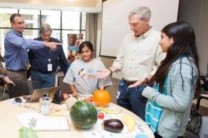 Intel CEO Brian Krzanich, CFO Stacy Smith and SVP Bill Holt talk with the YWCA’s TechGYRLS about their vegetable remix programmed with MIT’s Scratch software and a Makey Makey kit.