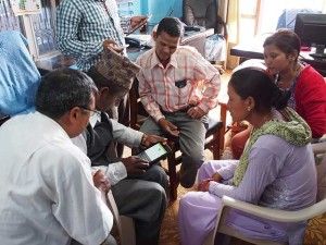 Karna Bahadur Buda (center), an entrepreneur from Nepal, receives training on the eAgro apps. “This changes everything for farmers,” says Srinivas Garudachar, director of business development for Gram
